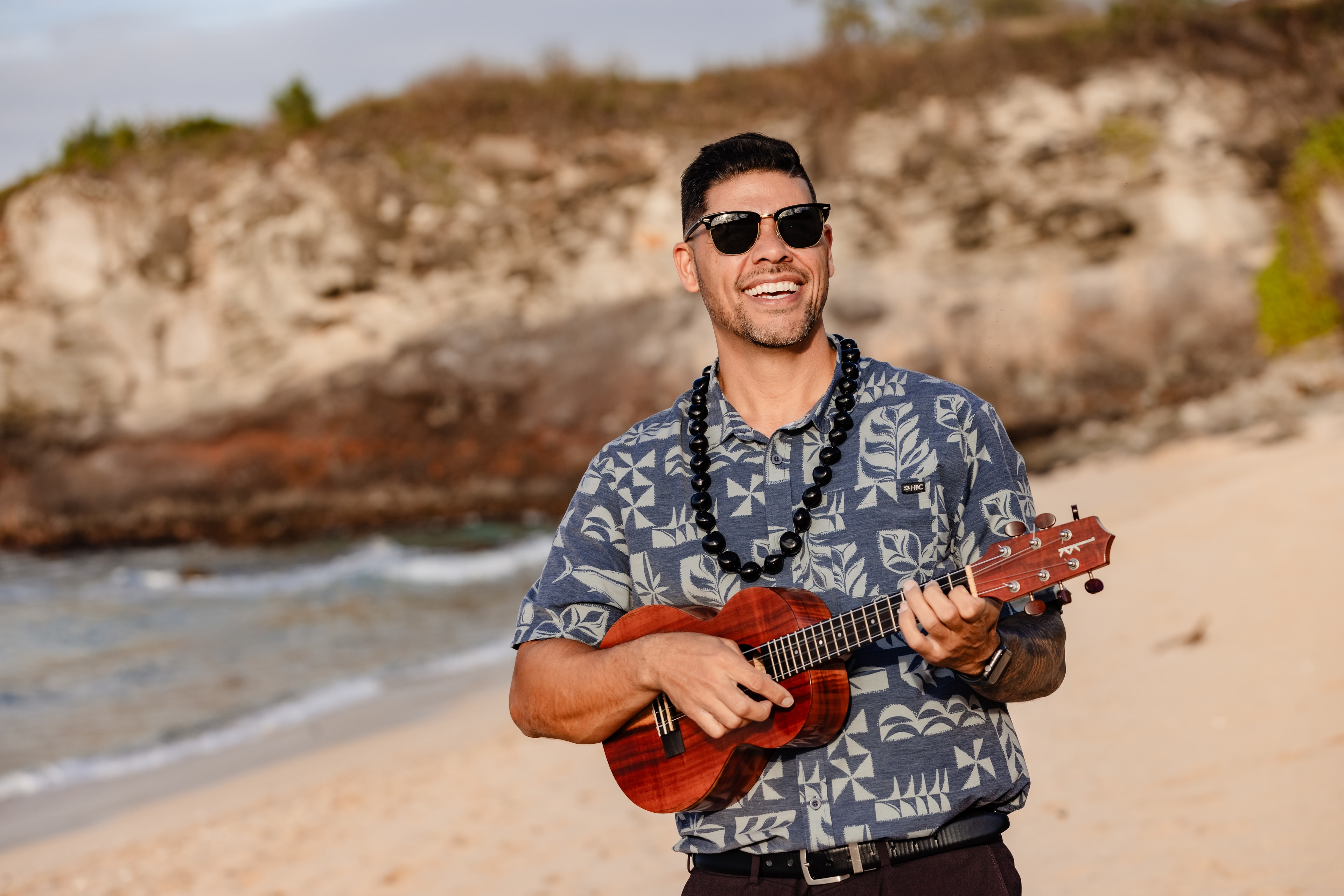 Kalo DeLeon playing ukulele on a Maui beach